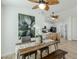 Bright dining room with a wood table, bench seating, and adjacent kitchen space at 4501 E Osage Ct, Phoenix, AZ 85044