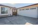 Home exterior with a double door entry and a white garage door at 4501 E Osage Ct, Phoenix, AZ 85044