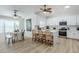 Bright and open kitchen with white cabinetry, modern appliances, and an adjacent dining area at 4501 E Osage Ct, Phoenix, AZ 85044