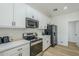 Modern kitchen with stainless steel appliances, white cabinets, and stylish countertop at 4501 E Osage Ct, Phoenix, AZ 85044