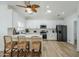 Well-lit kitchen with stainless steel appliances, white cabinets, and island seating at 4501 E Osage Ct, Phoenix, AZ 85044