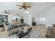 Spacious living room with wood-look floors, neutral-toned furniture, and plenty of natural light at 4501 E Osage Ct, Phoenix, AZ 85044