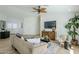 Living room featuring wood-look floors, a comfortable sofa, and a modern entertainment center at 4501 E Osage Ct, Phoenix, AZ 85044