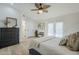 Spacious main bedroom with wood-look floors, a ceiling fan, and plenty of natural light at 4501 E Osage Ct, Phoenix, AZ 85044