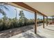 Wide view of the exterior patio featuring stained wood posts, concrete floors, and view of the backyard at 4501 E Osage Ct, Phoenix, AZ 85044