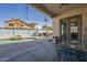 Covered patio with ceiling fan, exterior doors, pool with waterfall feature, and dining set at 4541 N 129Th Dr, Litchfield Park, AZ 85340