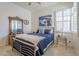 Bedroom featuring bright walls, wood accents, and a large window at 4541 N 129Th Dr, Litchfield Park, AZ 85340