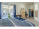 Bedroom with a blue accent wall, view of the patio and backyard at 4541 N 129Th Dr, Litchfield Park, AZ 85340