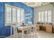 Bright dining area featuring a blue accent wall, natural light, and a stylish table and chairs at 4541 N 129Th Dr, Litchfield Park, AZ 85340