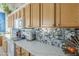 Bright kitchen with white countertops, sleek appliances, and decorative backsplash, ideal for cooking at 4541 N 129Th Dr, Litchfield Park, AZ 85340