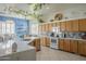 Bright kitchen featuring a center island with quartz countertops, tile backsplash, and modern appliances at 4541 N 129Th Dr, Litchfield Park, AZ 85340