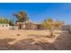 Spacious dirt backyard with a house and shed against a clear sky at 4550 W Bloomfield Rd, Glendale, AZ 85304