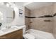 Classic bathroom with a sleek vanity, updated fixtures, and a tiled shower-tub combination at 4550 W Bloomfield Rd, Glendale, AZ 85304