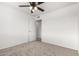 Neutral bedroom featuring plush carpeting, a ceiling fan, and a white door at 4550 W Bloomfield Rd, Glendale, AZ 85304