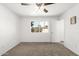 Inviting bedroom with plush carpet, a ceiling fan, and a window overlooking the yard at 4550 W Bloomfield Rd, Glendale, AZ 85304