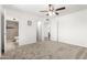 Airy bedroom with a ceiling fan, neutral carpet, and ensuite bathroom at 4550 W Bloomfield Rd, Glendale, AZ 85304