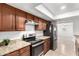 Well-lit kitchen featuring granite countertops, stainless steel appliances, and wood cabinetry at 4550 W Bloomfield Rd, Glendale, AZ 85304