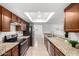 Well-lit kitchen featuring granite countertops, stainless steel appliances, and wood cabinetry at 4550 W Bloomfield Rd, Glendale, AZ 85304