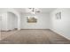 Bright living room featuring plush carpet, ceiling fan, large window and tiled entryway at 4550 W Bloomfield Rd, Glendale, AZ 85304