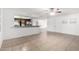 Bright living room featuring tiled floors, neutral walls, ceiling fan and kitchen access at 4550 W Bloomfield Rd, Glendale, AZ 85304