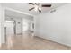 Bright living room featuring tiled floors, neutral walls, ceiling fan and kitchen access at 4550 W Bloomfield Rd, Glendale, AZ 85304