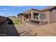 Backyard featuring a covered patio, outdoor kitchen, pergola, artificial turf, and desert landscaping at 4658 S Rufino Ln, Gold Canyon, AZ 85118