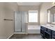 Modern bathroom features a shower, soaking tub, and single sink vanity at 4658 S Rufino Ln, Gold Canyon, AZ 85118