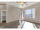 Bright bedroom with hardwood floors, ceiling fan, and a door leading to the backyard at 4658 S Rufino Ln, Gold Canyon, AZ 85118