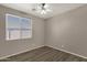 Simple bedroom with wood floors, neutral walls, and large window with blinds at 4658 S Rufino Ln, Gold Canyon, AZ 85118