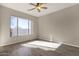 Sunlit bedroom with a ceiling fan and hardwood floors at 4658 S Rufino Ln, Gold Canyon, AZ 85118