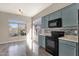 Bright kitchen features wood floors, stainless appliances, tile backsplash, and large window at 4658 S Rufino Ln, Gold Canyon, AZ 85118