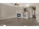 Spacious living room with fireplace, built-in shelving, wood floors, and neutral walls at 4658 S Rufino Ln, Gold Canyon, AZ 85118