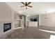 Open living room with fireplace, built-in shelving, wood floors, and kitchen view at 4658 S Rufino Ln, Gold Canyon, AZ 85118