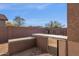 Outdoor kitchen with concrete countertop and stainless steel fridge, perfect for entertaining guests at 4658 S Rufino Ln, Gold Canyon, AZ 85118