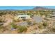 Aerial view of modern home with a private pool, landscaped yard, and desert surroundings, showcasing its serene location at 5468 E Dove Valley Rd, Cave Creek, AZ 85331