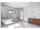 Bright bathroom featuring marble flooring, glass enclosed shower with soaking tub, and a dark wood vanity at 5468 E Dove Valley Rd, Cave Creek, AZ 85331