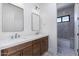 Modern bathroom with a double sink vanity with white countertop and dark wood cabinets at 5468 E Dove Valley Rd, Cave Creek, AZ 85331