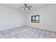 Bright, minimalist bedroom with neutral carpet, a ceiling fan, and outdoor views at 5468 E Dove Valley Rd, Cave Creek, AZ 85331