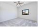 Spacious bedroom featuring neutral carpet, a ceiling fan, and an outdoor view at 5468 E Dove Valley Rd, Cave Creek, AZ 85331