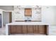 Close-up of the kitchen island with white countertop, wooden cabinets, and pendant lights at 5468 E Dove Valley Rd, Cave Creek, AZ 85331