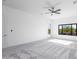 Bright main bedroom with neutral walls, carpet floors, a ceiling fan and a large window at 5468 E Dove Valley Rd, Cave Creek, AZ 85331