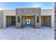 Expansive covered patio features stone columns, tiled flooring, and a cozy outdoor fireplace at 5468 E Dove Valley Rd, Cave Creek, AZ 85331