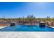 Beautiful pool featuring stone waterfalls and desert landscaping, set against a stunning blue sky at 5468 E Dove Valley Rd, Cave Creek, AZ 85331