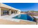 A stunning backyard pool with a waterfall feature and tiled patio for outdoor relaxation and entertainment at 5468 E Dove Valley Rd, Cave Creek, AZ 85331