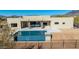 Backyard pool with patio, waterfall features, desert landscaping and perimeter fence at 5468 E Dove Valley Rd, Cave Creek, AZ 85331