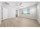 Bedroom with wood floors, ceiling fan, and large window at 550 W Copper Way, Chandler, AZ 85225