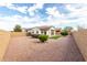 Fully fenced backyard with desert landscaping, synthetic grass, and covered patio space at 5624 S Winchester --, Mesa, AZ 85212