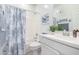 Bright bathroom with white vanity and blue-themed shower curtain at 5624 S Winchester --, Mesa, AZ 85212