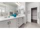 Bright bathroom featuring white cabinets, double sinks, and a large mirror at 5624 S Winchester --, Mesa, AZ 85212