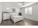 Bright bedroom with white furniture, plantation shutters, and a ceiling fan at 5624 S Winchester --, Mesa, AZ 85212